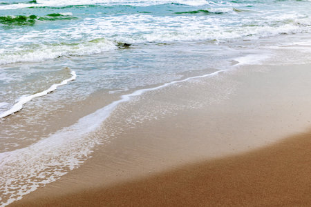 240623223-tranquil-waves-on-sandy-beach-with-gentle-surf-and-clear-skies